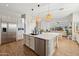 Spacious open kitchen with stainless steel appliances, a center island, and views into the living area at 3917 E Patrick Ln, Phoenix, AZ 85050
