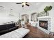 Bright living room with fireplace, white walls, wood floors and modern furnishings at 3917 E Patrick Ln, Phoenix, AZ 85050