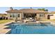 Inviting backyard pool and spa featuring stone accents and patio seating, perfect for outdoor entertaining at 3917 E Patrick Ln, Phoenix, AZ 85050