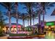 Outdoor shopping with palm trees with lights, dining, and storefronts at Desert Ridge Marketplace at 3917 E Patrick Ln, Phoenix, AZ 85050