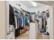 Walk-in closet with shelves and hanging rods for storage; tiled floor at 3917 E Patrick Ln, Phoenix, AZ 85050