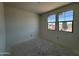 A bedroom with 2 windows is shown at 46868 W Old Timer Rd, Maricopa, AZ 85139