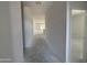 A long hallway is shown going to the back of the house at 46868 W Old Timer Rd, Maricopa, AZ 85139