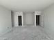 An unfinished living room with multiple doorways is shown at 46868 W Old Timer Rd, Maricopa, AZ 85139