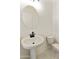 This is a small bathroom with a bright pedestal sink and comfort-height toilet for guests to use at 4933 W Capistrano Ave, Laveen, AZ 85339