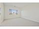 Bright, carpeted bedroom offers ample natural light from large windows at 4933 W Capistrano Ave, Laveen, AZ 85339