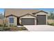 Charming single-story home featuring a 2-car and a single-car garage and low maintenance desert landscaping at 4933 W Capistrano Ave, Laveen, AZ 85339