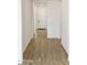 Bright hallway with wood-look flooring and a view of the front door at 4933 W Capistrano Ave, Laveen, AZ 85339