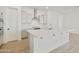Kitchen boasts white cabinetry, stainless steel appliances, and a center island with counter seating at 4933 W Capistrano Ave, Laveen, AZ 85339