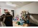 Spacious basement with tiled flooring, storage shelves, and a variety of household items at 5637 N 63Rd Dr, Glendale, AZ 85301