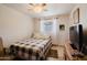 Cozy bedroom with a ceiling fan and a white-framed window overlooking the exterior at 5637 N 63Rd Dr, Glendale, AZ 85301