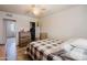 Bedroom features tile floors, a ceiling fan, and a dresser near a closet at 5637 N 63Rd Dr, Glendale, AZ 85301