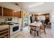 Bright kitchen area featuring a gas range and oven, a dining area, and sliding glass doors to the outside at 5637 N 63Rd Dr, Glendale, AZ 85301