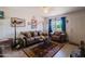Comfortable living room with tile floors, bright lighting, and brick accent wall at 5637 N 63Rd Dr, Glendale, AZ 85301