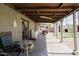 Covered patio with seating, a washing machine, and a partial view of the backyard shed at 5637 N 63Rd Dr, Glendale, AZ 85301