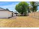 Spacious backyard with healthy grass and a shaded pergola with outdoor seating at 5912 E Wethersfield Rd, Scottsdale, AZ 85254