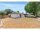 Expansive backyard features healthy grass, mature trees, and patio seating area at 5912 E Wethersfield Rd, Scottsdale, AZ 85254