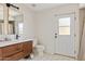 Contemporary bathroom featuring wood vanity, modern fixtures, and hexagonal tile floor at 5912 E Wethersfield Rd, Scottsdale, AZ 85254