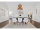 Sunlit dining room showcasing a modern table set, bright white walls, and a decorative pendant light fixture at 5912 E Wethersfield Rd, Scottsdale, AZ 85254