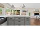 Kitchen island with modern cabinets, stone countertops, and pendant lighting at 5912 E Wethersfield Rd, Scottsdale, AZ 85254