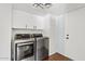 Laundry room with full-sized washer and dryer and storage cabinets at 5912 E Wethersfield Rd, Scottsdale, AZ 85254