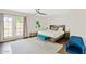 Primary bedroom featuring a king-sized bed, large window and ceiling fan at 5912 E Wethersfield Rd, Scottsdale, AZ 85254