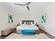 Bright main bedroom features neutral walls, ceiling fan, and a plush, comfortable king bed at 5912 E Wethersfield Rd, Scottsdale, AZ 85254