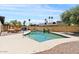 Backyard swimming pool with lounge chairs, desert landscaping, and a brick surround at 5912 E Wethersfield Rd, Scottsdale, AZ 85254