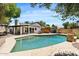 Backyard pool with brick surround and outdoor dining area and lounging spaces for entertaining at 5912 E Wethersfield Rd, Scottsdale, AZ 85254