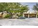 Exterior elevation with lush front yard landscaping and a circular driveway at 6306 N Camelback Manor Dr, Paradise Valley, AZ 85253