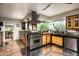 Open kitchen area with stainless steel appliances, custom cabinets, and views of the backyard at 6306 N Camelback Manor Dr, Paradise Valley, AZ 85253