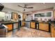 Bright kitchen featuring stainless appliances, custom cabinets and countertop, and stone floors at 6306 N Camelback Manor Dr, Paradise Valley, AZ 85253