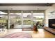 Modern living room with wood flooring, fireplace, balcony views, and natural light at 6306 N Camelback Manor Dr, Paradise Valley, AZ 85253