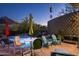 Charming backyard patio area with comfortable seating, lush greenery, and a sparkling pool at 6306 N Camelback Manor Dr, Paradise Valley, AZ 85253