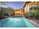 Stunning backyard pool and patio area with outdoor seating, lush landscaping, and modern architecture at 6306 N Camelback Manor Dr, Paradise Valley, AZ 85253
