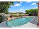 Lush backyard with a pool and mountain views in the distance at 6376 W Louise Dr, Glendale, AZ 85310