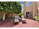 Private backyard patio with lounge chairs, shaded by a leafy tree at 6376 W Louise Dr, Glendale, AZ 85310