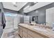 Modern bathroom featuring double sinks and a glass-enclosed shower at 6376 W Louise Dr, Glendale, AZ 85310