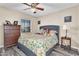 Comfortable bedroom with a window and a wooden dresser at 6376 W Louise Dr, Glendale, AZ 85310