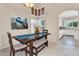Dining area boasts a decorative light fixture, corner windows, and a view of the kitchen beyond at 6376 W Louise Dr, Glendale, AZ 85310