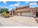 Charming two-story home with a three-car garage, tile roof, well-manicured lawn, and vibrant landscaping at 6376 W Louise Dr, Glendale, AZ 85310