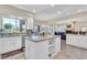 Bright kitchen with granite countertops, island, tile flooring, and stainless steel appliances at 6376 W Louise Dr, Glendale, AZ 85310