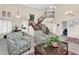 Spacious living room with a grand staircase, high ceilings, and lots of natural light at 6376 W Louise Dr, Glendale, AZ 85310