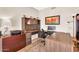 This home office boasts a built-in desk and shelving, ample workspace, and a cohesive design scheme at 6376 W Louise Dr, Glendale, AZ 85310