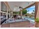 Expansive covered patio overlooking a refreshing pool and beautifully landscaped backyard with comfortable wicker seating at 6376 W Louise Dr, Glendale, AZ 85310