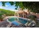 Serene backyard with a sparkling pool, lush landscaping, and a covered patio, creating a private oasis at 6376 W Louise Dr, Glendale, AZ 85310