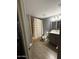Bathroom with shower, light gray walls, a wood-look tile floor, and vanity at 6429 W Palm Ln, Phoenix, AZ 85035