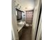 Bathroom featuring white vanity, marble countertops, and a shower with curtain at 6429 W Palm Ln, Phoenix, AZ 85035