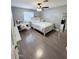 Comfortable bedroom with gray paint, light wood floors, and a white vanity/desk at 6429 W Palm Ln, Phoenix, AZ 85035