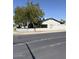 Street view of a block wall surrounding a property with mature trees at 6429 W Palm Ln, Phoenix, AZ 85035